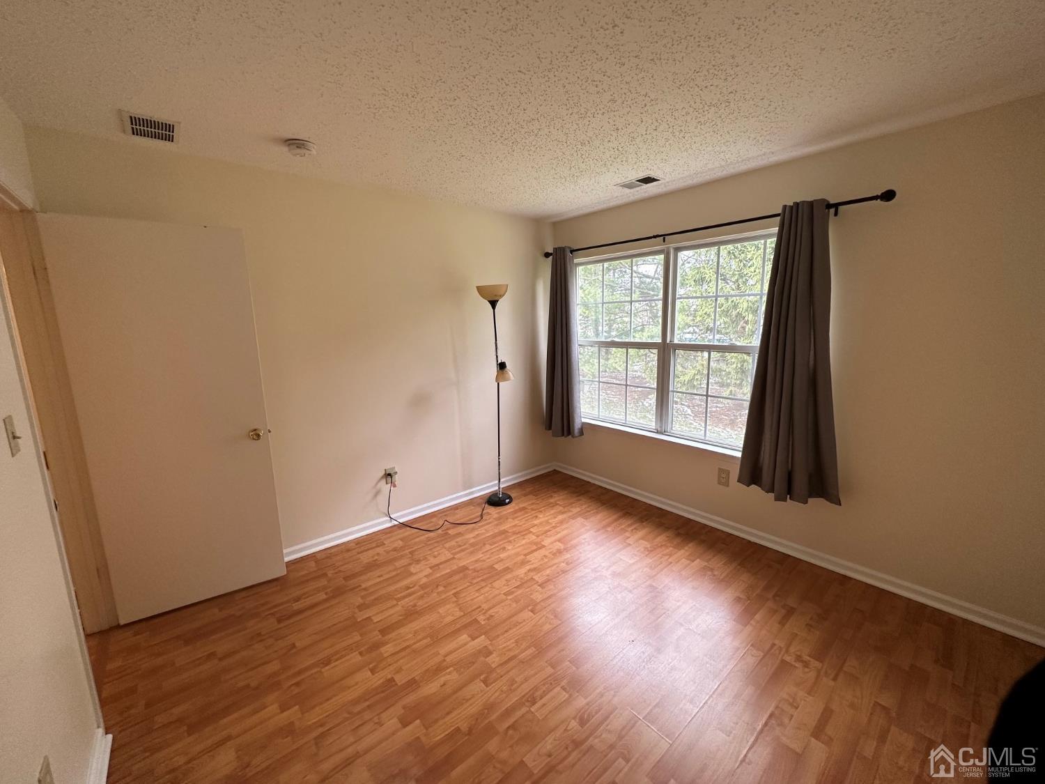 260 Nebula Road Piscataway, NJ 08854 - Photo 38 of 46 a view of an empty room with wooden floor and a window