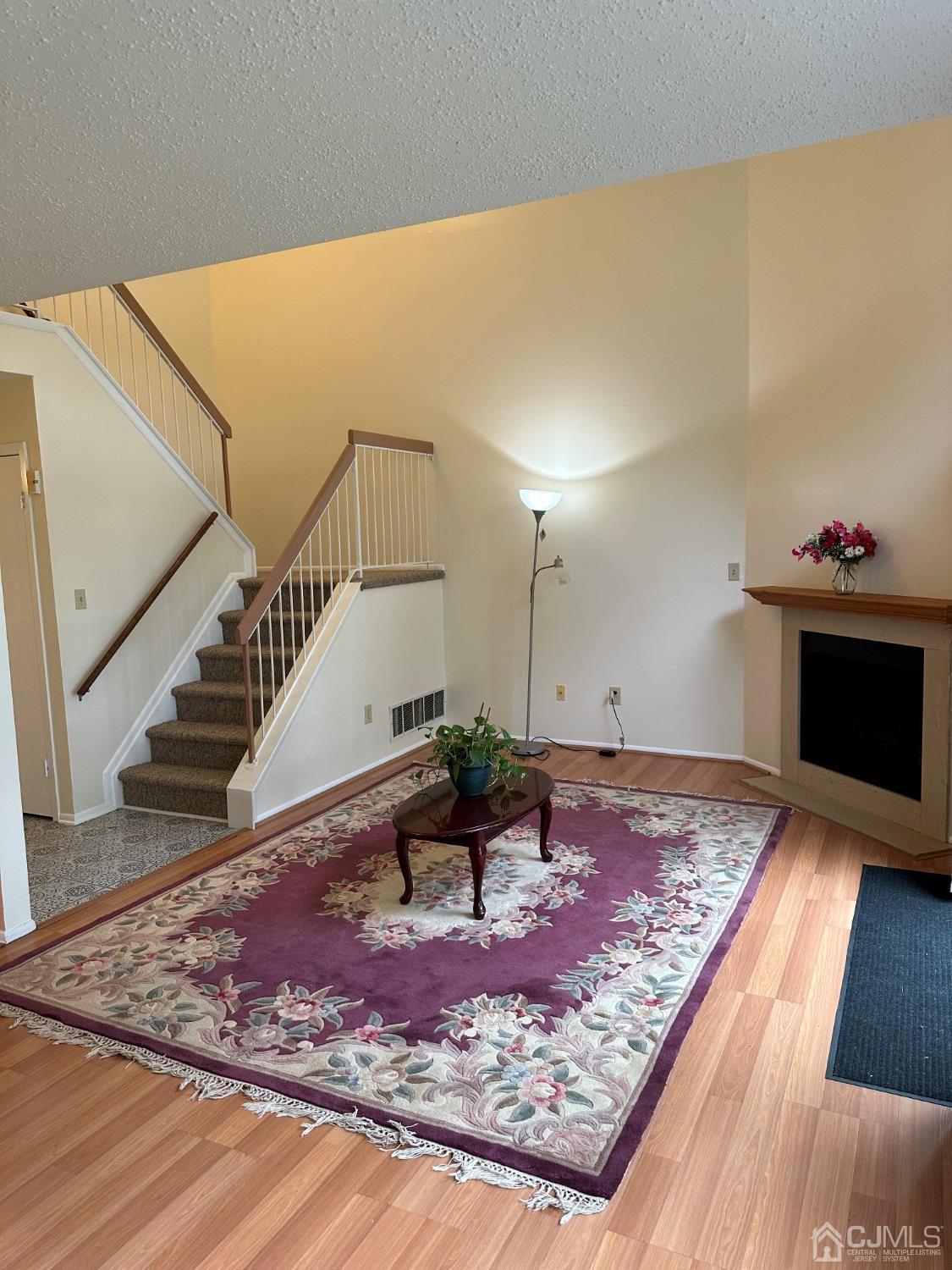 260 Nebula Road Piscataway, NJ 08854 - Photo 9 of 46 a view of a hallway with wooden floor and a fireplace