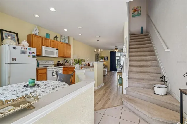 a kitchen with stainless steel appliances kitchen island granite countertop a refrigerator and a stove top oven