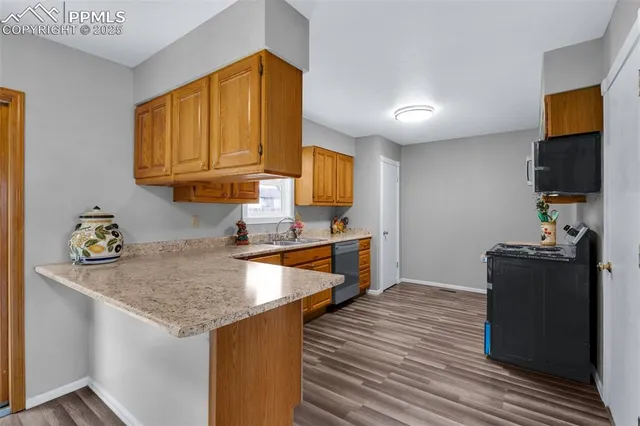 a kitchen with granite countertop a stove and a sink
