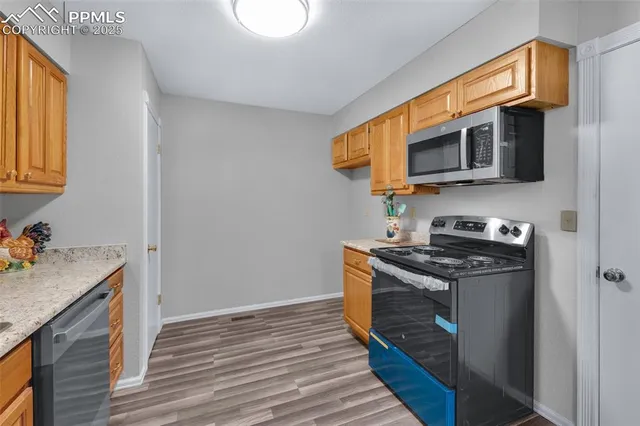 a kitchen with stainless steel appliances granite countertop a stove and a microwave
