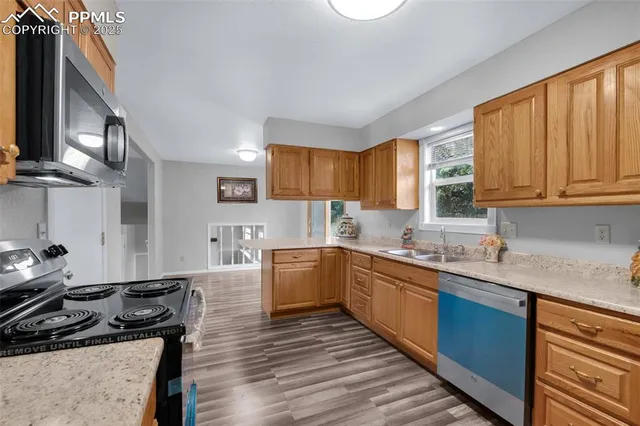 a kitchen with a sink stove and cabinets