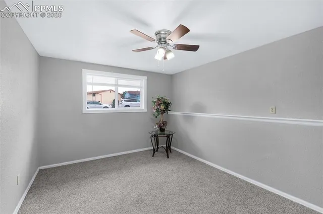 a view of a hallway with a window and a ceiling fan