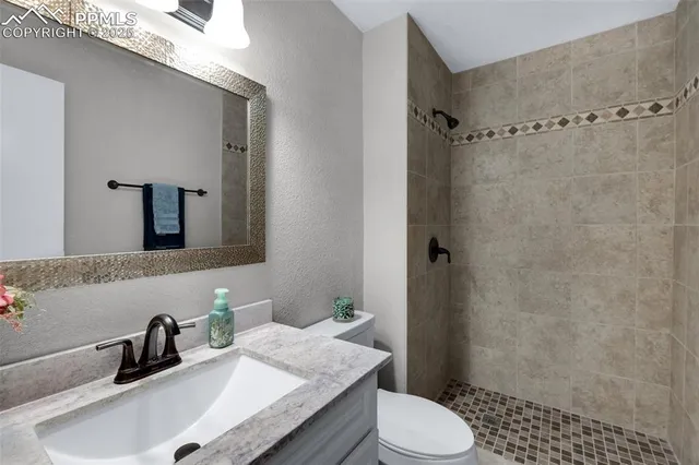 a view of a room with window and ceiling fan