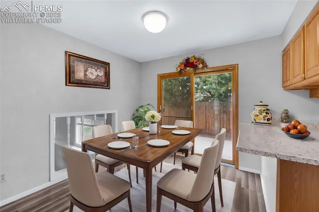 a view of a dining room with furniture window and wooden floor