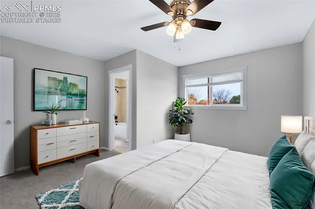 a bedroom with a bed and a chandelier fan