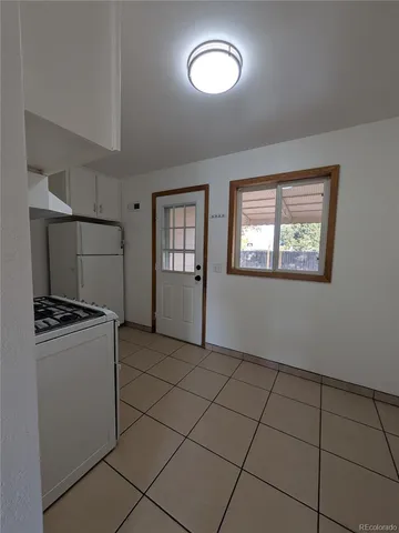 a kitchen with granite countertop a stove top oven and cabinets