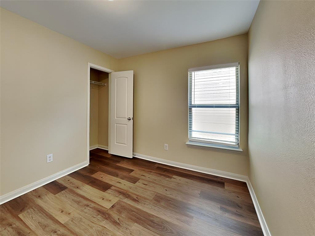 1334 Barrel Drive Dallas, TX 75253 - Photo 12 of 15 an empty room with wooden floor and windows