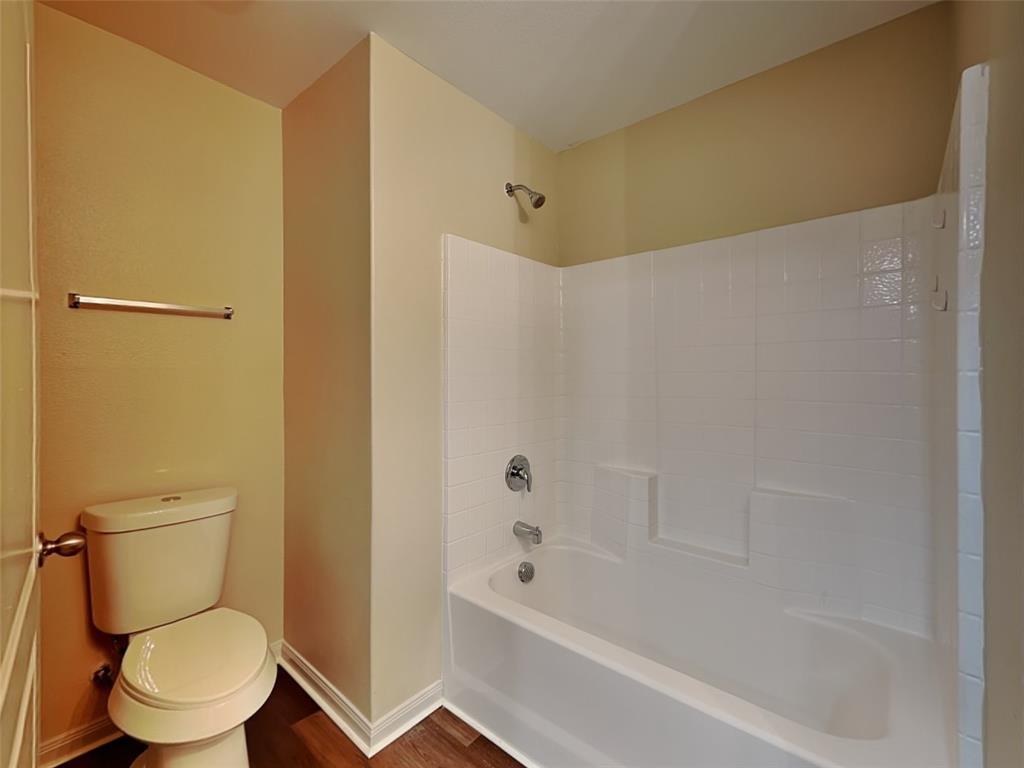 1334 Barrel Drive Dallas, TX 75253 - Photo 13 of 15 a white toilet sitting next to a bath tub