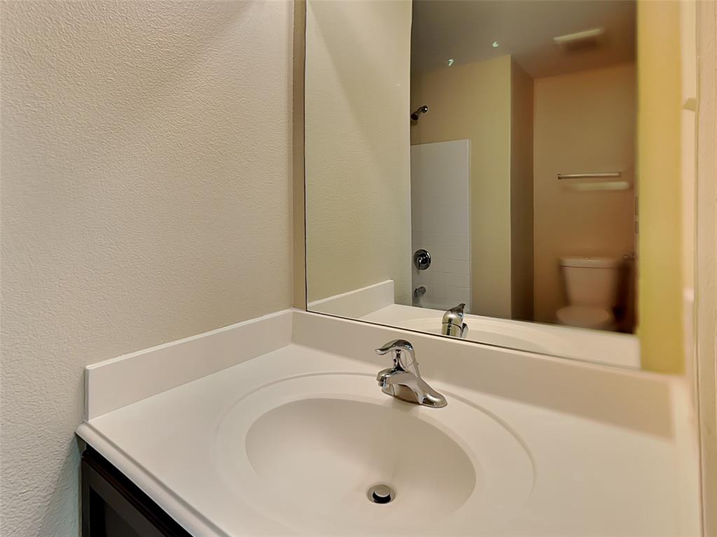 1334 Barrel Drive Dallas, TX 75253 - Photo 14 of 15 a bathroom with a sink and a mirror