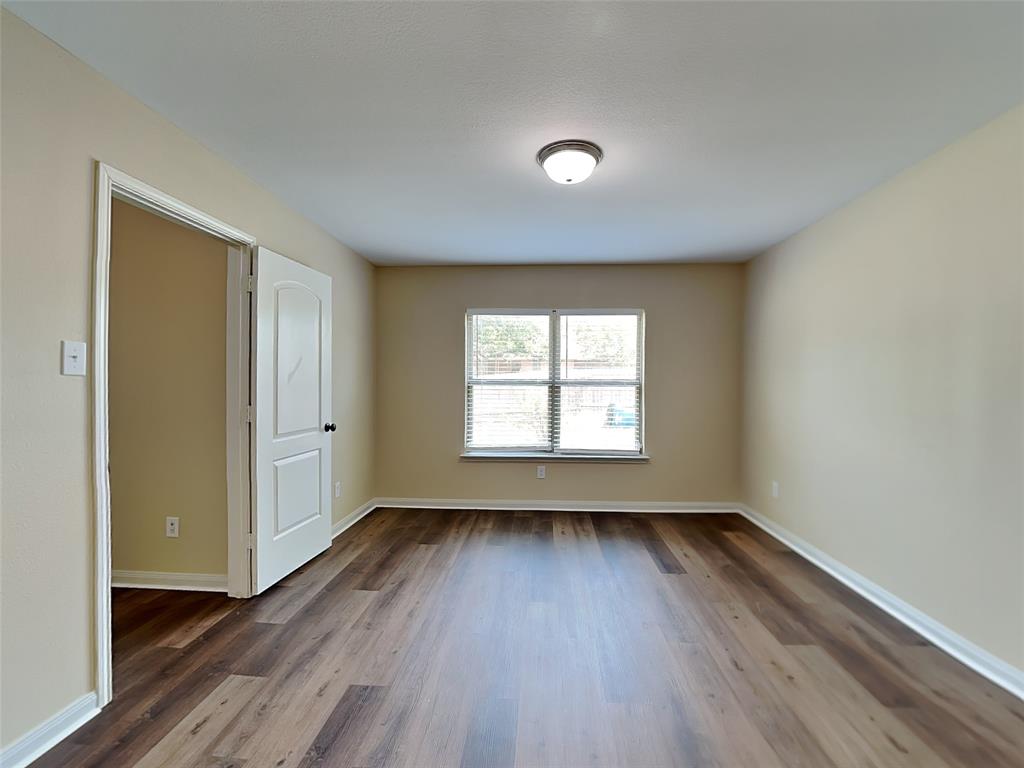 1334 Barrel Drive Dallas, TX 75253 - Photo 2 of 15 an empty room with wooden floor and windows