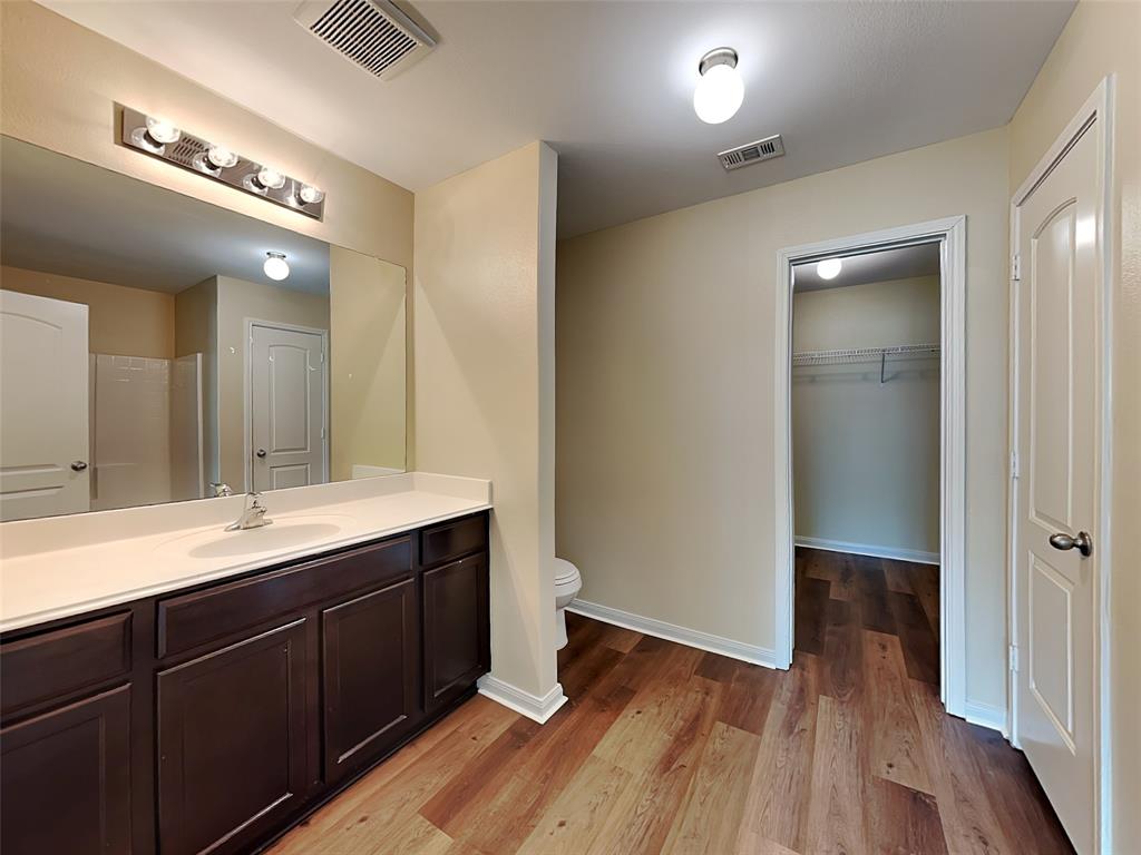 1334 Barrel Drive Dallas, TX 75253 - Photo 3 of 15 a bathroom with a double vanity sink and mirror