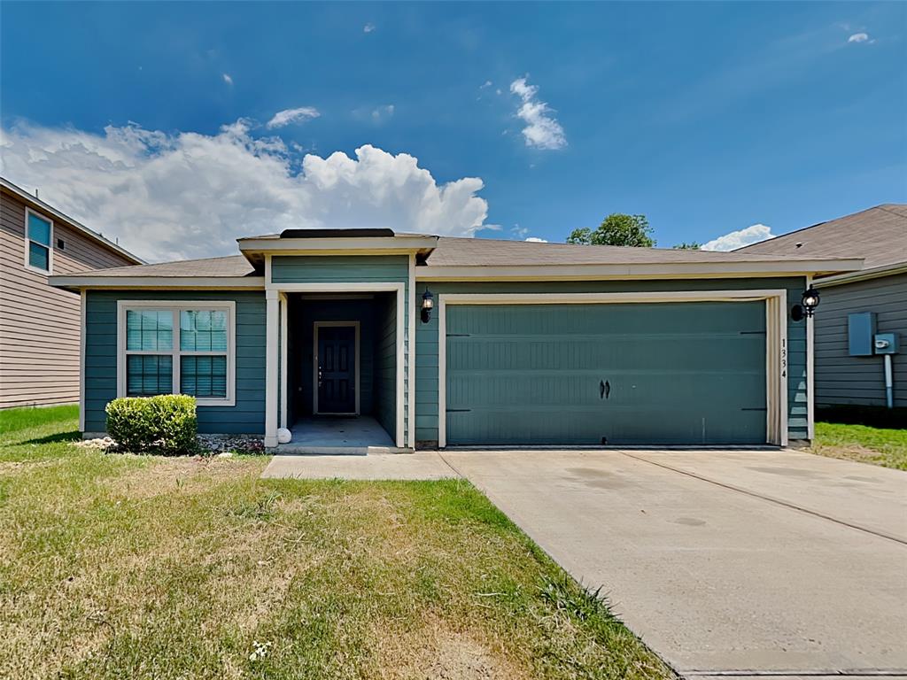 1334 Barrel Drive Dallas, TX 75253 - Photo 5 of 15 a front view of a house with a yard and garage