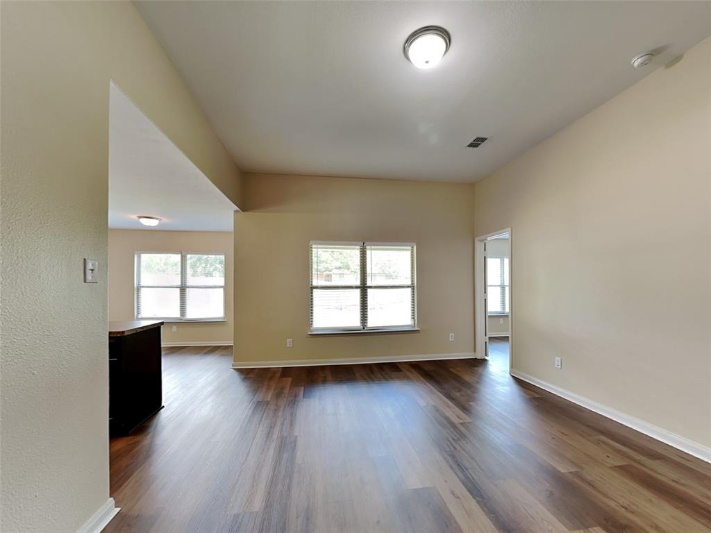 1334 Barrel Drive Dallas, TX 75253 - Photo 6 of 15 an empty room with wooden floor and windows