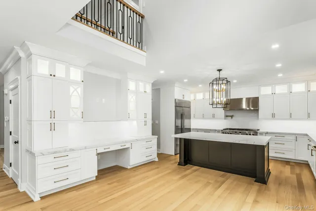 a large kitchen with stainless steel appliances granite countertop a stove and a sink