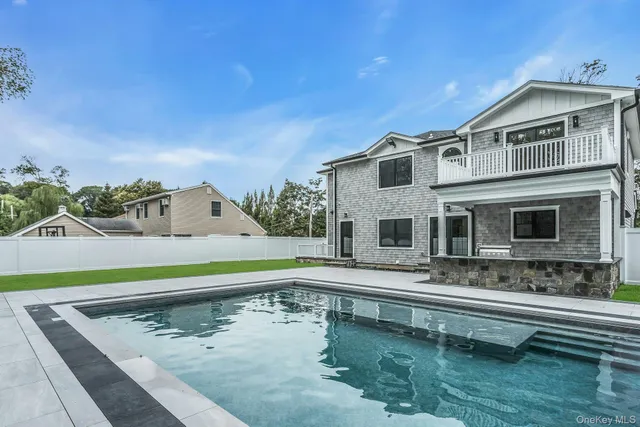 a view of a house with swimming pool and sitting area