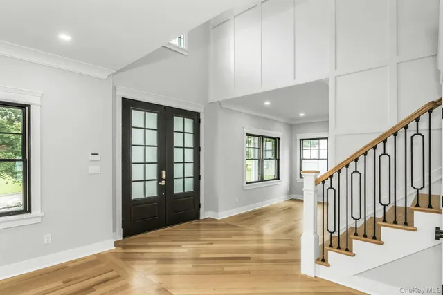 a view of an entryway with wooden floor and door