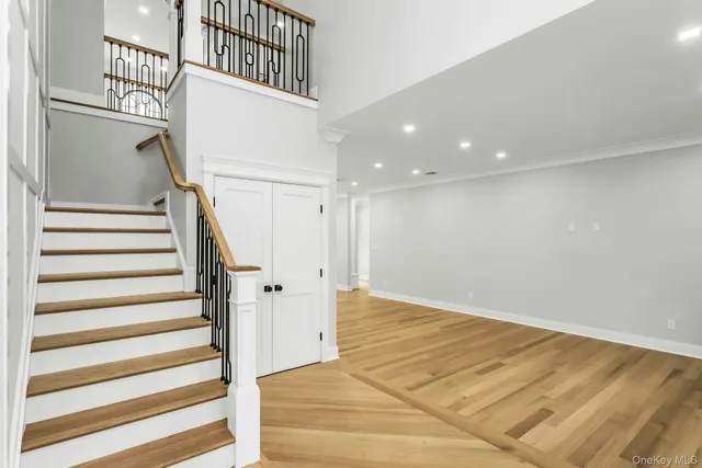 a view of entryway with wooden floor and stairs