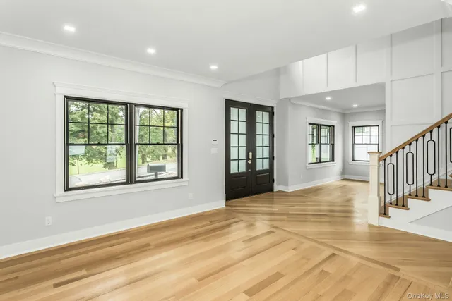 a view of an entryway with wooden floor and a window