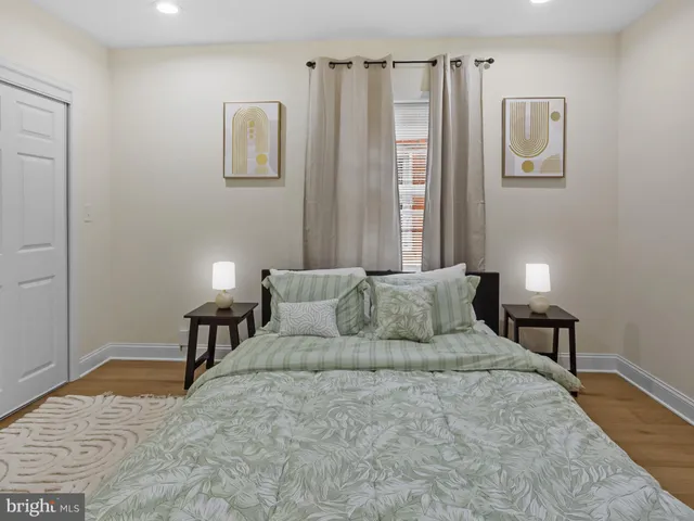 a large bedroom with a bed and furniture