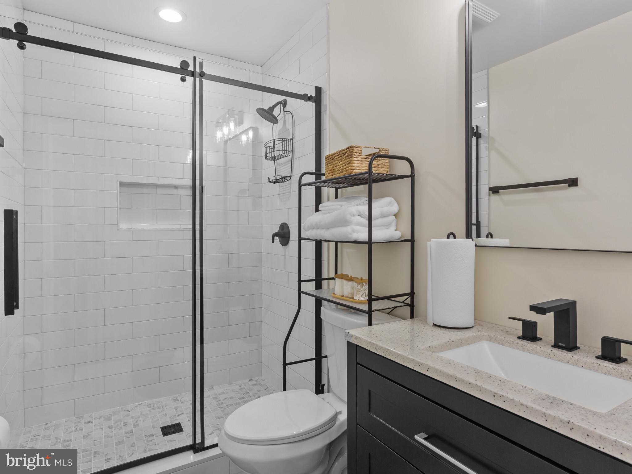 1834 Providence Street Northeast Washington, DC 20002 - Photo 20 of 25 a bathroom with a granite countertop sink toilet and shower