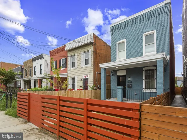 a view of a house with a balcony and wooden floor