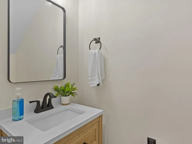 a bathroom with a sink and mirror