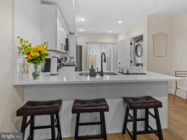 a kitchen with a table chairs refrigerator and sink