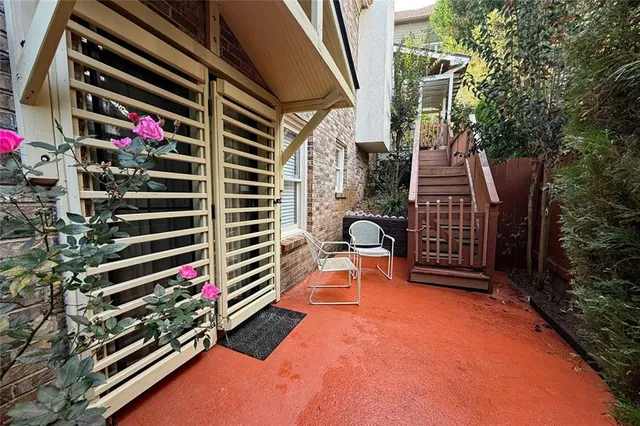 a backyard of a house with barbeque oven and trees