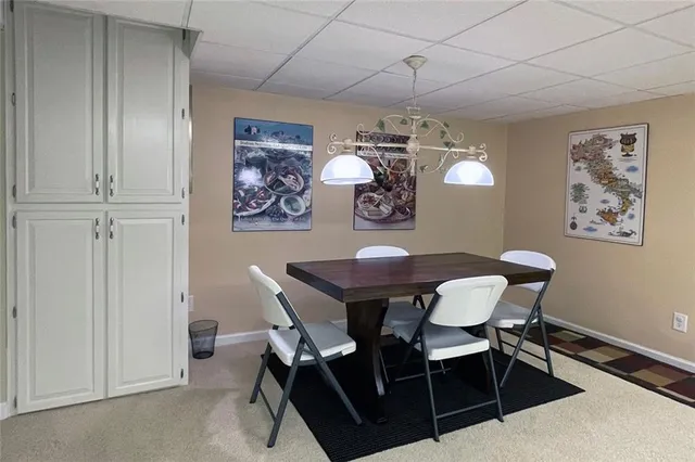 a view of a dining room with furniture and chandelier