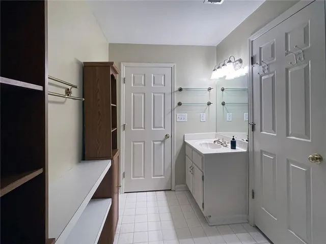 a bathroom with a sink a mirror and a shower