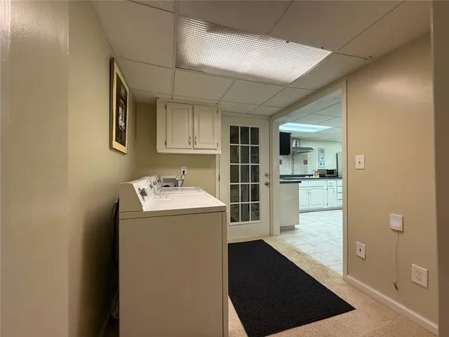 a view of a kitchen with fridge and a sink