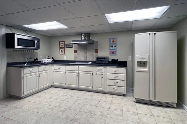 a kitchen with a stove a sink and a refrigerator