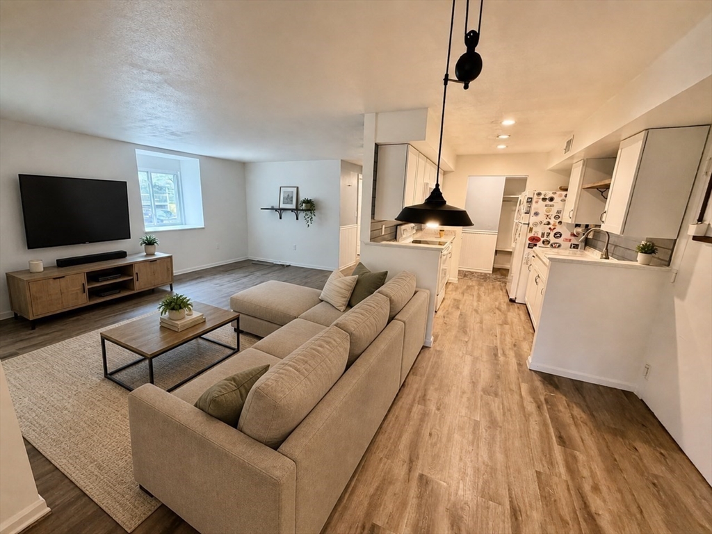 13 Beal's Cove Road, Unit K Hingham, MA 02043 - Photo 2 of 7 a living room with furniture and a flat screen tv