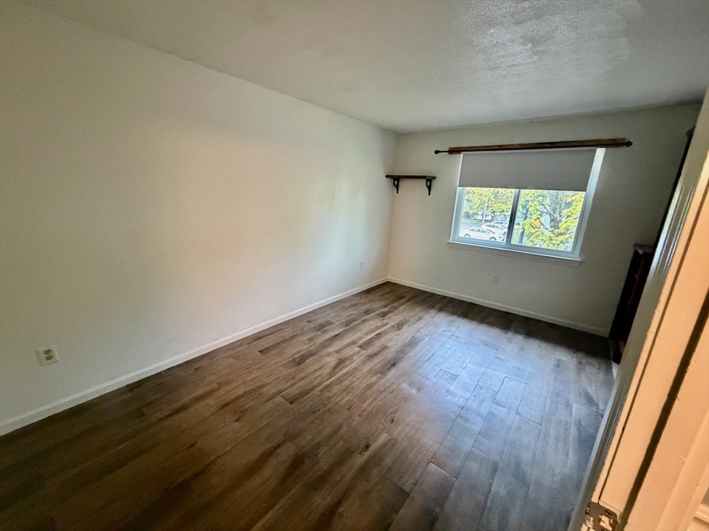 13 Beal's Cove Road, Unit K Hingham, MA 02043 - Photo 5 of 7 an empty room with windows
