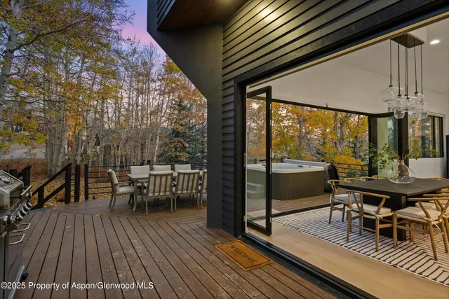 a view of a chairs and table in patio with wooden floor
