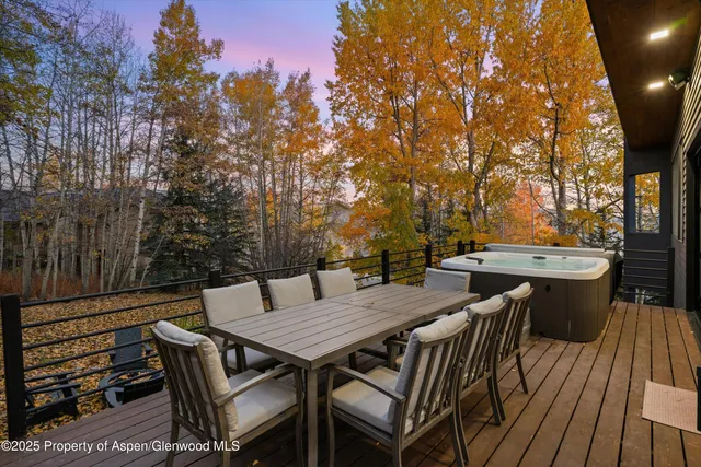 a view of a dinning table and chairs on the roof deck