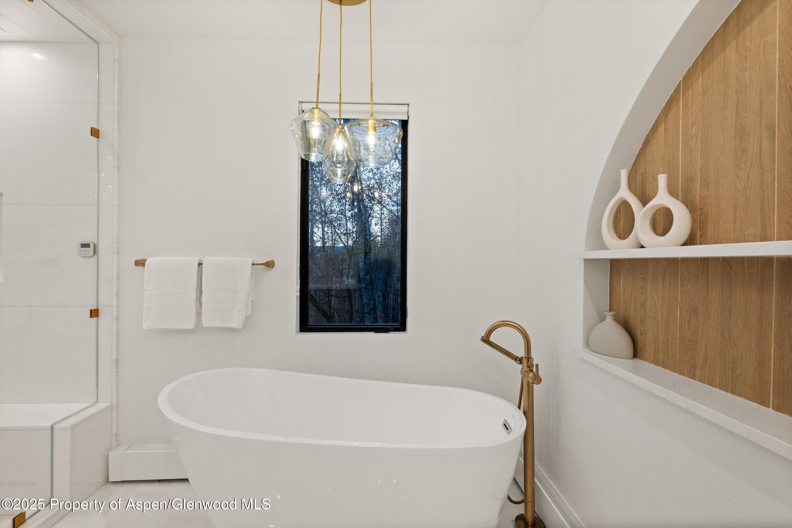 233 Stellar Lane Snowmass Village, CO 81615 - Photo 25 of 43 a white bath tub sitting next to a shower
