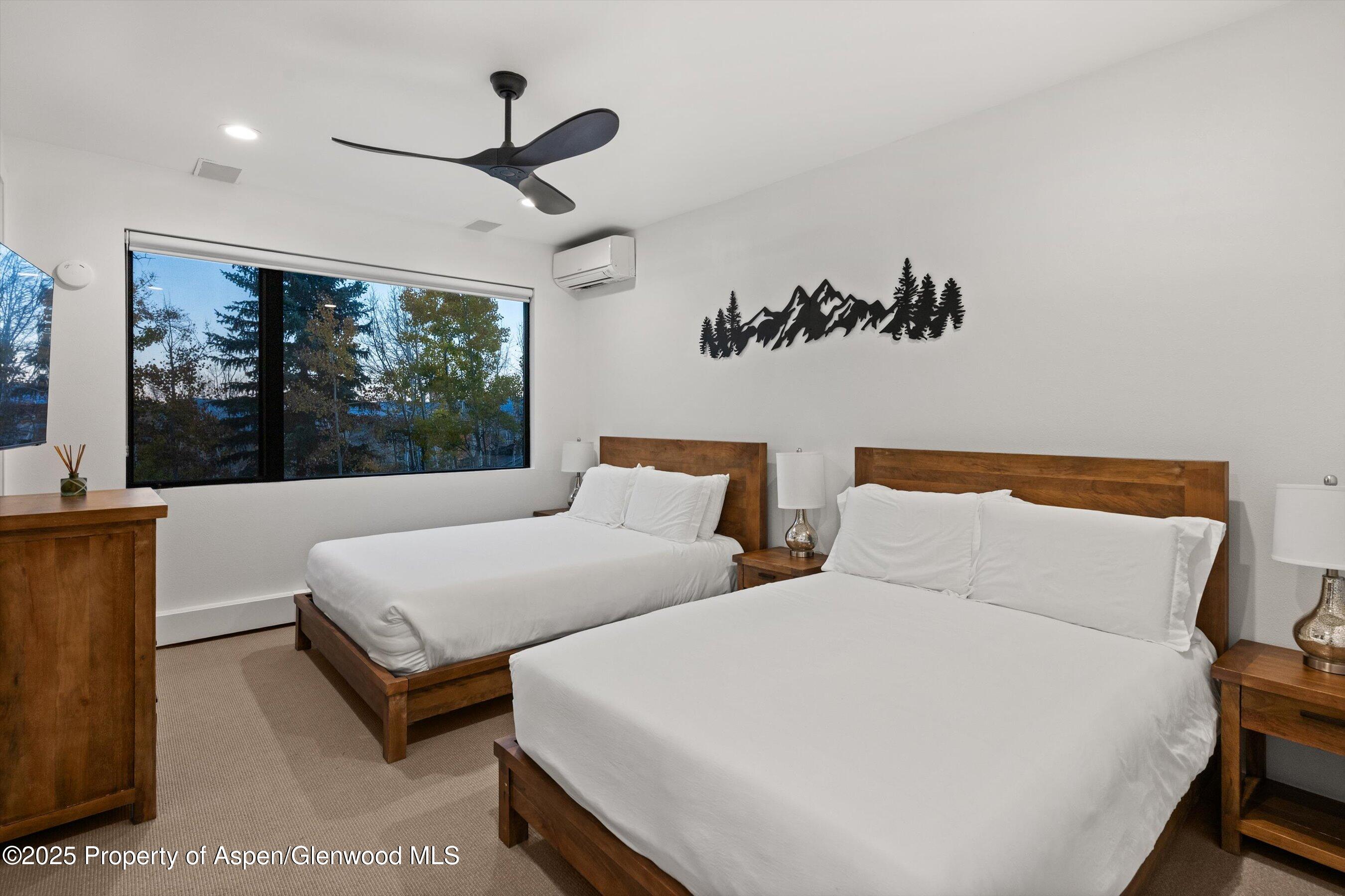 233 Stellar Lane Snowmass Village, CO 81615 - Photo 28 of 43 a bedroom with two beds and large window