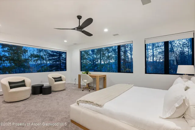 a bedroom with a large bed and a large window