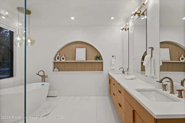 a bathroom with a double vanity sink a mirror and shower