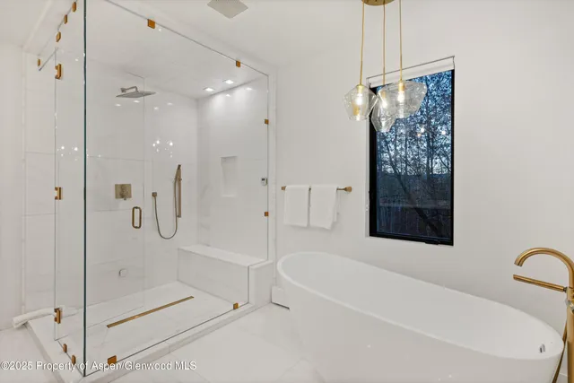 a bathroom with a bathtub shower and toilet