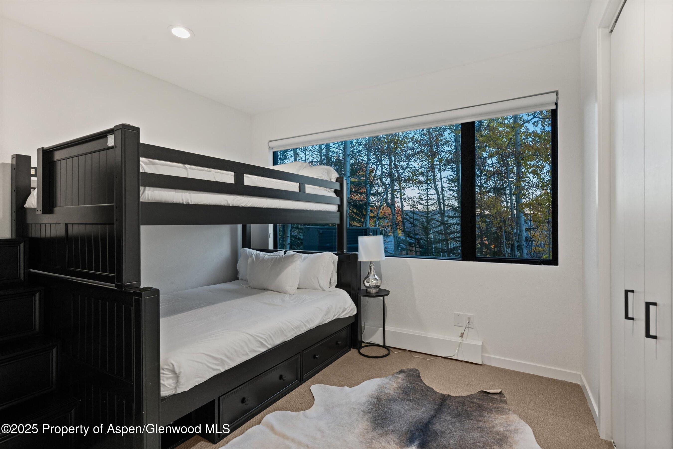 233 Stellar Lane Snowmass Village, CO 81615 - Photo 34 of 43 a bedroom with a bed and large window