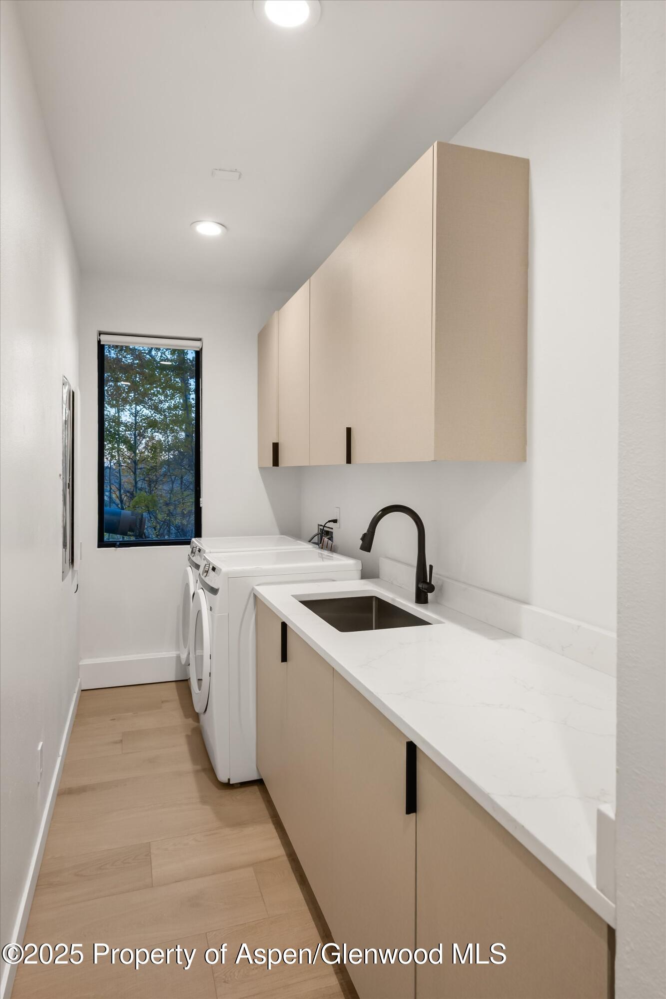 233 Stellar Lane Snowmass Village, CO 81615 - Photo 37 of 43 a view of a kitchen with kitchen island a sink wooden floor and a large window