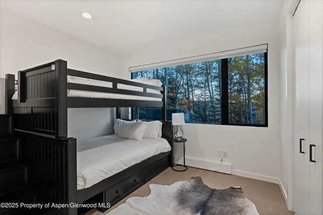 a bedroom with a bed and large window