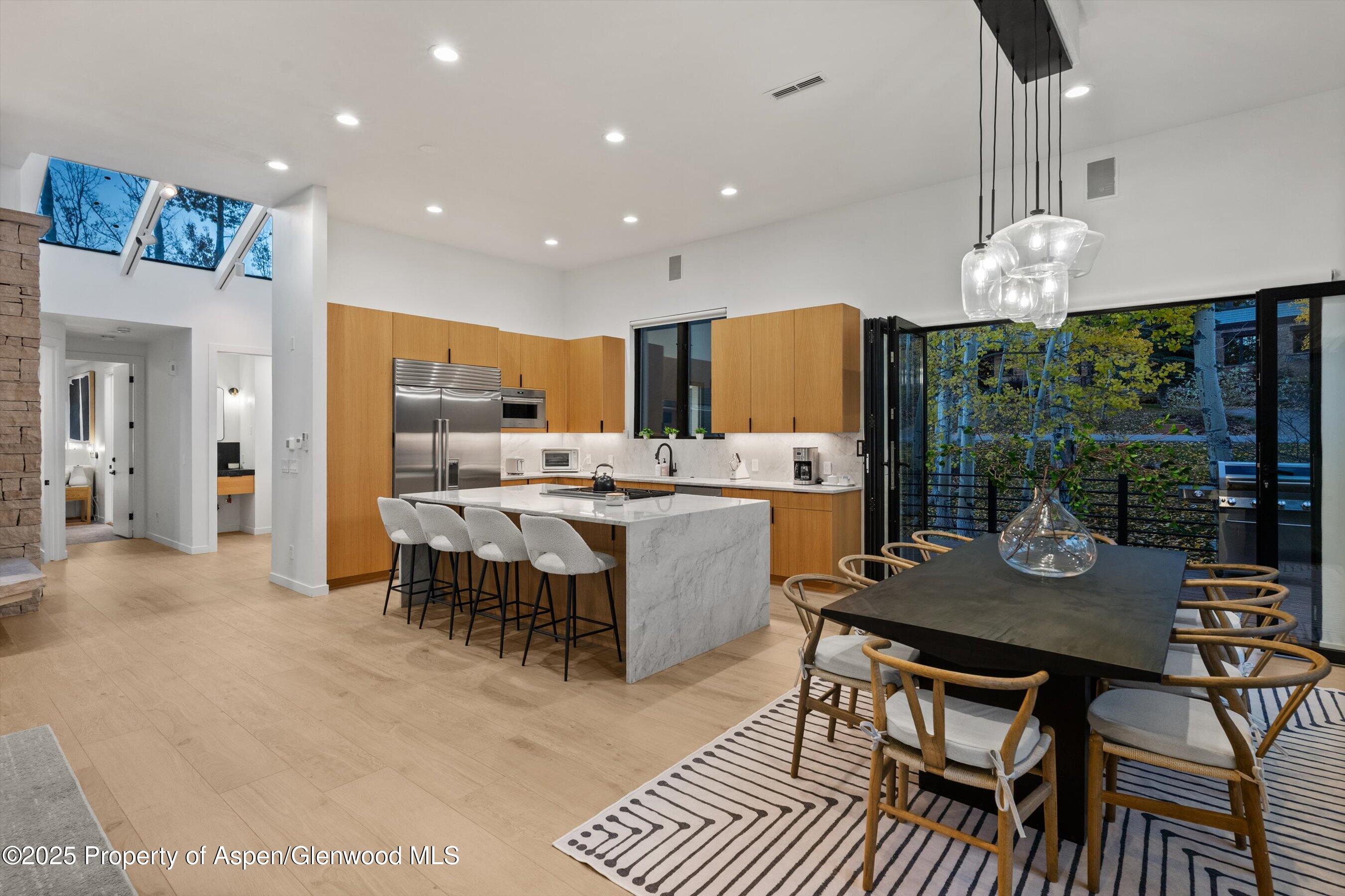 233 Stellar Lane Snowmass Village, CO 81615 - Photo 8 of 43 a large kitchen with a table and chairs