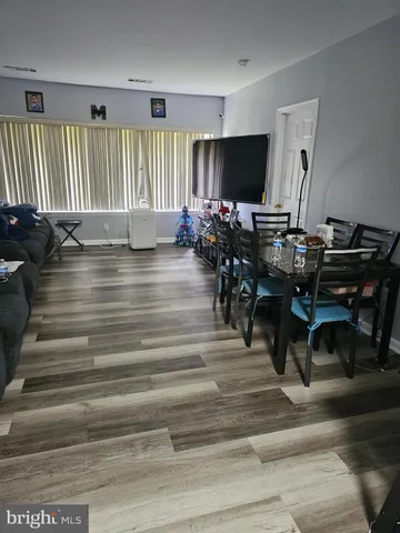 a view of a livingroom with furniture and a floor to ceiling window
