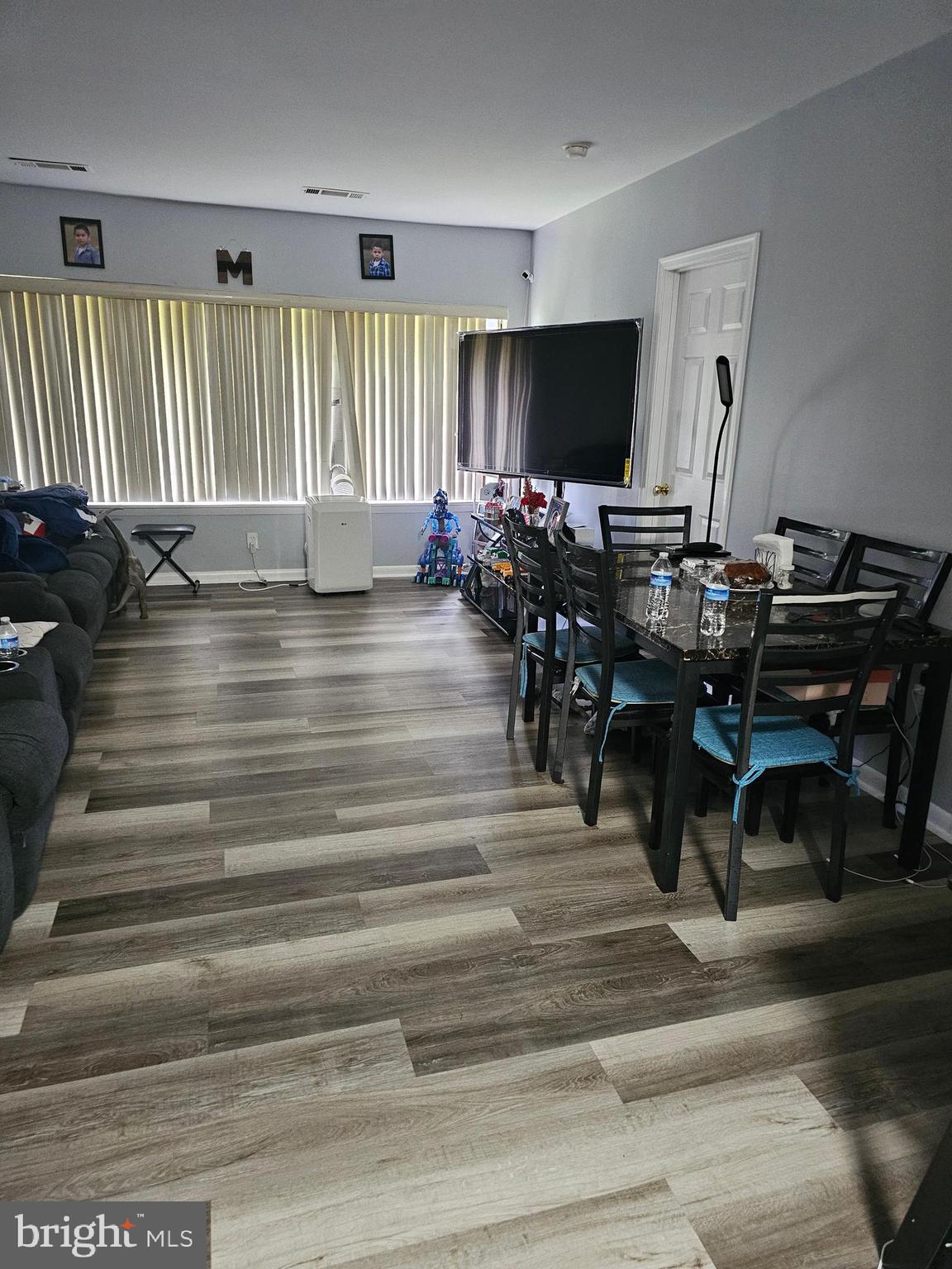 a view of a livingroom with furniture and a floor to ceiling window