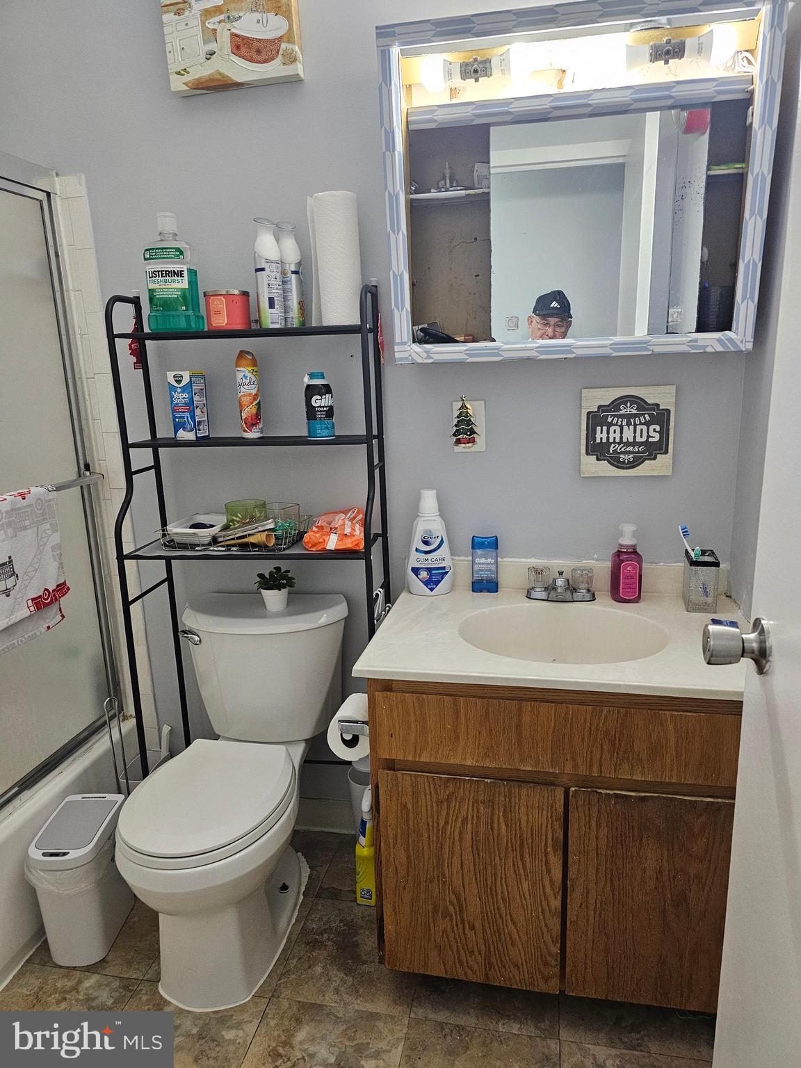 9802 Walker House Road, Unit 6 Gaithersburg, MD 20886 - Photo 2 of 4 a bathroom with a sink a toilet and a mirror