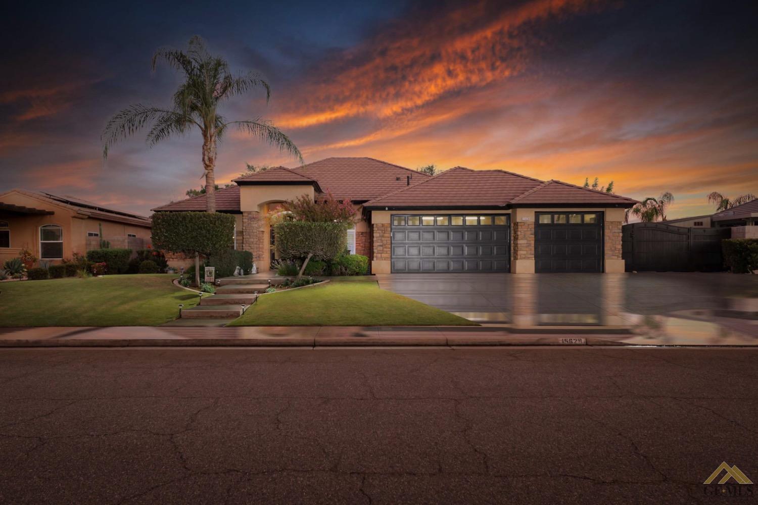 a front view of a house with a garden and yard